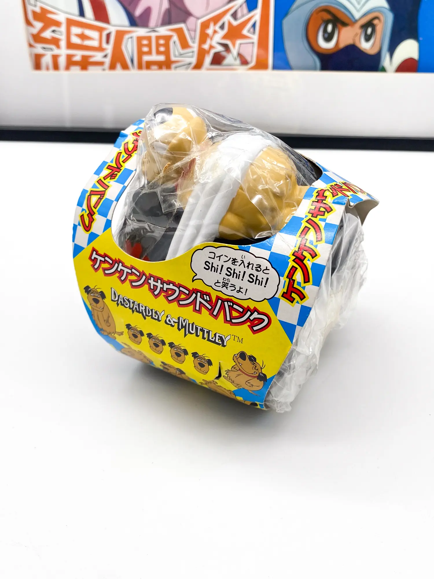 Tirelire Diabolo Muttley dans son sachet et son bandeau japonais Sound Bank