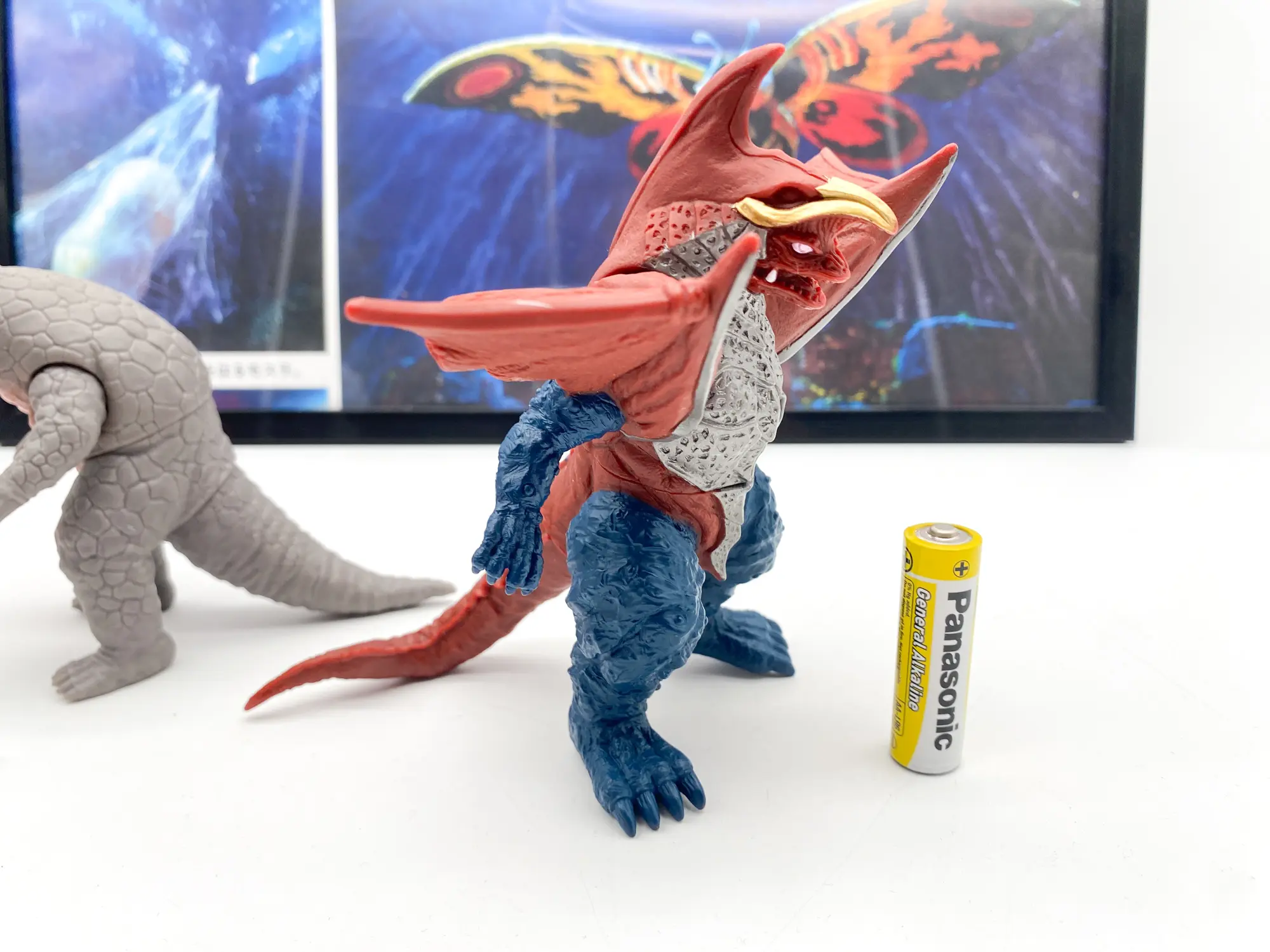 Bandai Ultra Monster 500 Golber soft vinyl kaiju figure, Ultraman, side view with AA battery for scale